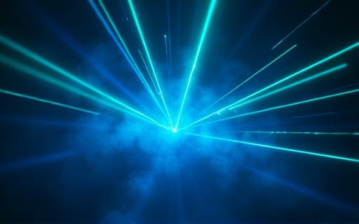 A blue and green laser light show in a dark room